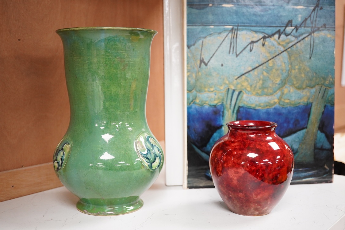 A Moorcroft for Liberty & Co. Flamminion Ware vase, and a smaller Moorcroft vase glazed in a mottled plum flambe, the first 20cm., also to include two Moorcroft reference books